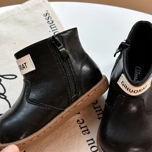 Black leather children's ankle boots with side zipper and soft rubber sole
