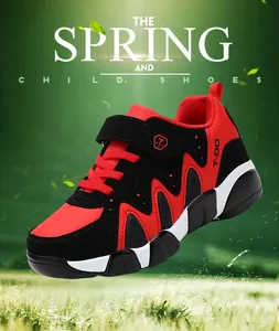 Detailed side view of a red and black boys' athletic sneaker with velcro strap