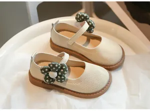 Detailansicht der cremefarbenen Mädchen-Prinzessin-Schuhe mit grüner Punkt-Blume