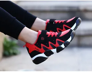 Side view of durable red and black boys' athletic running sneakers with hook-and-loop straps