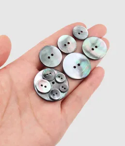Close-up detail of iridescent natural black mother-of-pearl shell buttons in various sizes