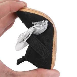 Close-up showing the flexibility of black baby girl princess shoes with a soft non-slip sole
