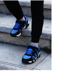 Detailed action shot showing blue and black durable boys' sports shoes on outdoor stone stairs