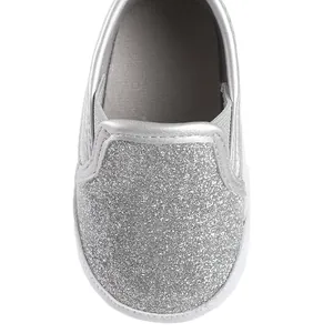 Macro view showing the shiny silver glitter detail on children's soft sole walking shoes