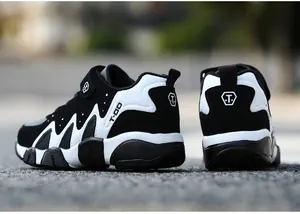 Detailed rear view of boys' black and white leather sports shoes with anti-slip soles