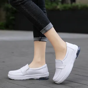Comfortable white slip-on nursing work shoes with blue air cushion on model's feet