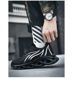 Side view of black mesh sports sneakers with white wave patterns and chunky soles