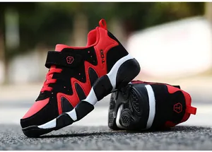 Detailed macro view of red and black boy's sports shoes featuring durable non-slip soles.