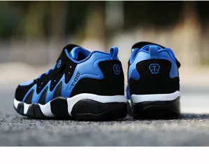 Rear view of durable blue and black kids' sneakers showing sole texture and heel support
