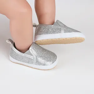 Close-up of silver glitter baby shoes with soft soles for newborns and toddlers