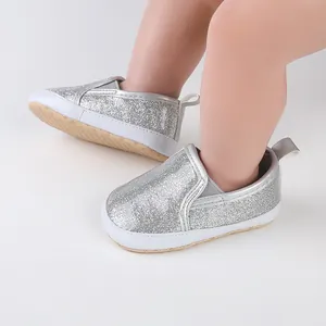 Silver sparkly baby pre-walker shoes with soft soles for newborn boys and girls.