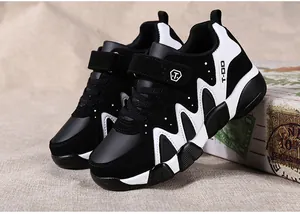 Black and white boys athletic sneakers with velcro strap and durable leather surface