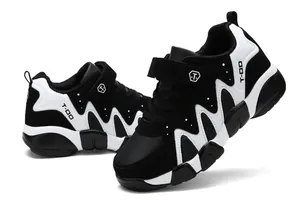 Close-up detail showing the side profile of boys' black and white leather running shoes