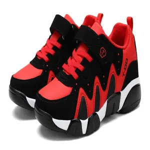 Close-up of red and black boys athletic shoes with durable non-slip soles for active running