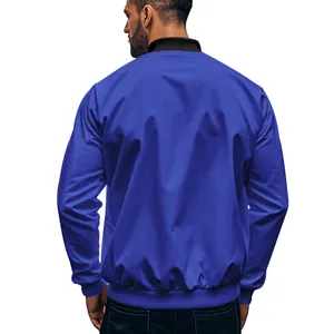 Rear view of a premium royal blue twill bomber jacket for men featuring a black stand-up collar