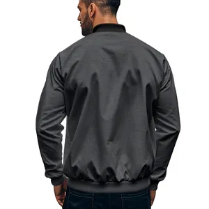 Back view of a mens charcoal grey bomber jacket with twill texture and ribbed hem.