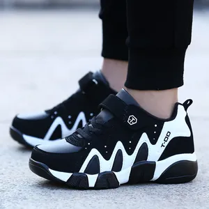 Boys casual sports sneakers in black and white leather finish, durable running shoes.