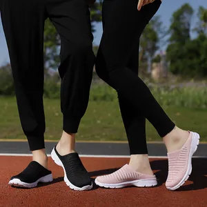 Breathable fly-knit mesh slip-on mules for outdoor travel, available in black and pink colors.