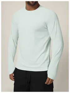 Seamless men's quick-dry sports long-sleeve t-shirt in pale mint green for gym or outdoor
