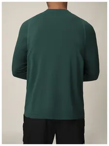 Back view of a dark green seamless quick-dry long-sleeved athletic t-shirt for men
