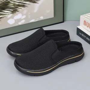 Black breathable mesh slip-on mules for men featuring a sporty thick sole with gold detail