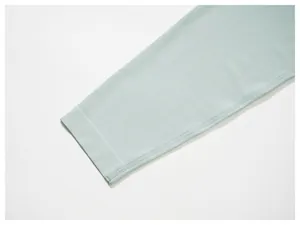 Close-up detail of seamless cuff and breathable mesh fabric on light blue athletic t-shirt