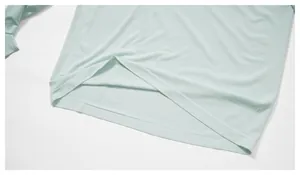 Close-up of seamless hem detail on mint green quick-dry sports long-sleeve T-shirt