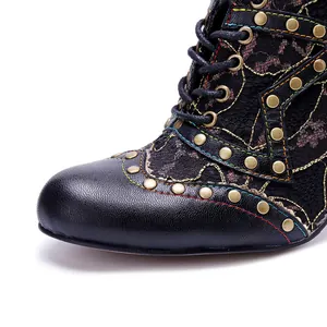 Detailed view of handmade leather high heel shoes with lace and metal rivet accents