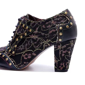 Close-up detail of vintage lace patchwork high heels featuring bronze rivets and gold embroidery