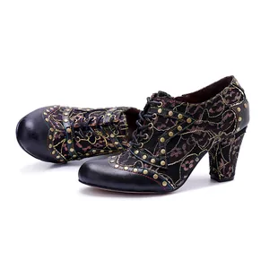 Detailed view of vintage handmade leather heels with floral splicing and rivet accents