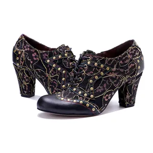 Close-up of vintage handmade leather high heels with rivet studs and lace pattern