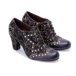 Vintage style high heels featuring lace embroidery, studs, and leather texture