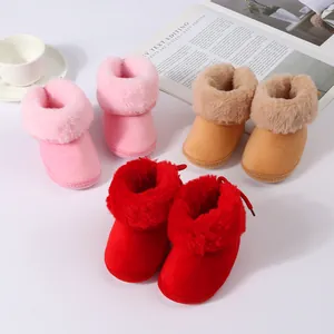 Close-up of cozy baby winter boots with plush faux fur collar in pink, tan and red