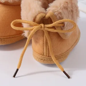 Detailed macro shot of the decorative bow and soft faux fur lining on baby winter boots
