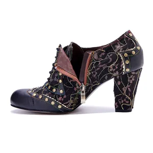 Retro leather high-heeled bootie featuring metallic studs and lace floral embroidery detail