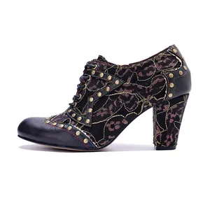 Side view of retro black lace and leather patchwork high-heeled bootie with rivets