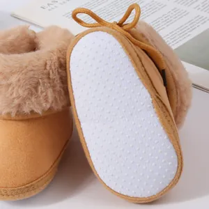 Macro detail of non-slip dotted sole and soft faux fur lining on baby winter walking boots