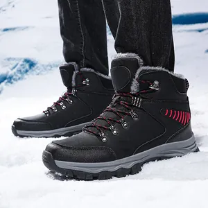 Detailed side view of men's black outdoor hiking snow boots with red accents in snow