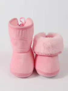 Detailed view of soft pink baby winter boots showing the plush faux fur lining texture
