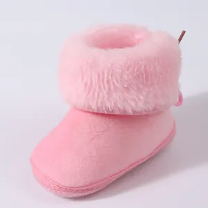 Close-up of pink plush baby winter bootie with soft fluffy faux fur collar detail