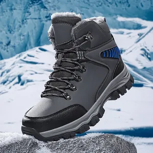 Men's grey waterproof hiking snow boots with warm fur lining in snowy mountains