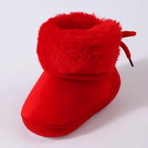 Close-up of vibrant red baby winter boot featuring soft faux fur trim and warm cotton lining.
