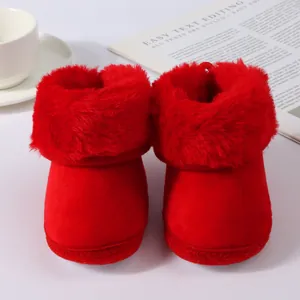 Detail view of cozy red baby winter boots with soft faux fur lining and plush texture