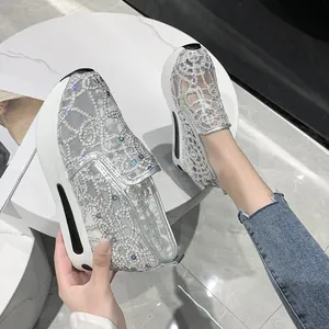 A close-up detail of women's silver lace mesh platform loafers with sparkling rhinestones