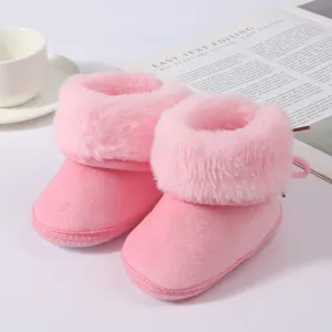 Close-up view of pink infant winter boots with soft plush fur collar and warm suede finish