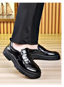 Detailed side view of polished black genuine cowhide leather business loafers for men.
