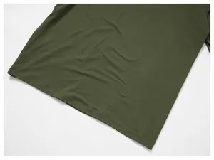 Detail view showing the hem and fabric texture of olive green quick-dry sports top