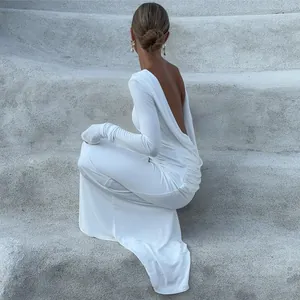 Detailed close-up showing the elegant backless design of white long sleeve dress