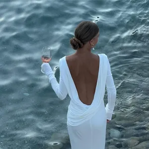 Back view of elegant white long sleeve maxi dress with draped backless design