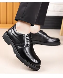 Close-up profile view of men's black leather dress shoes with thick soles and round toes